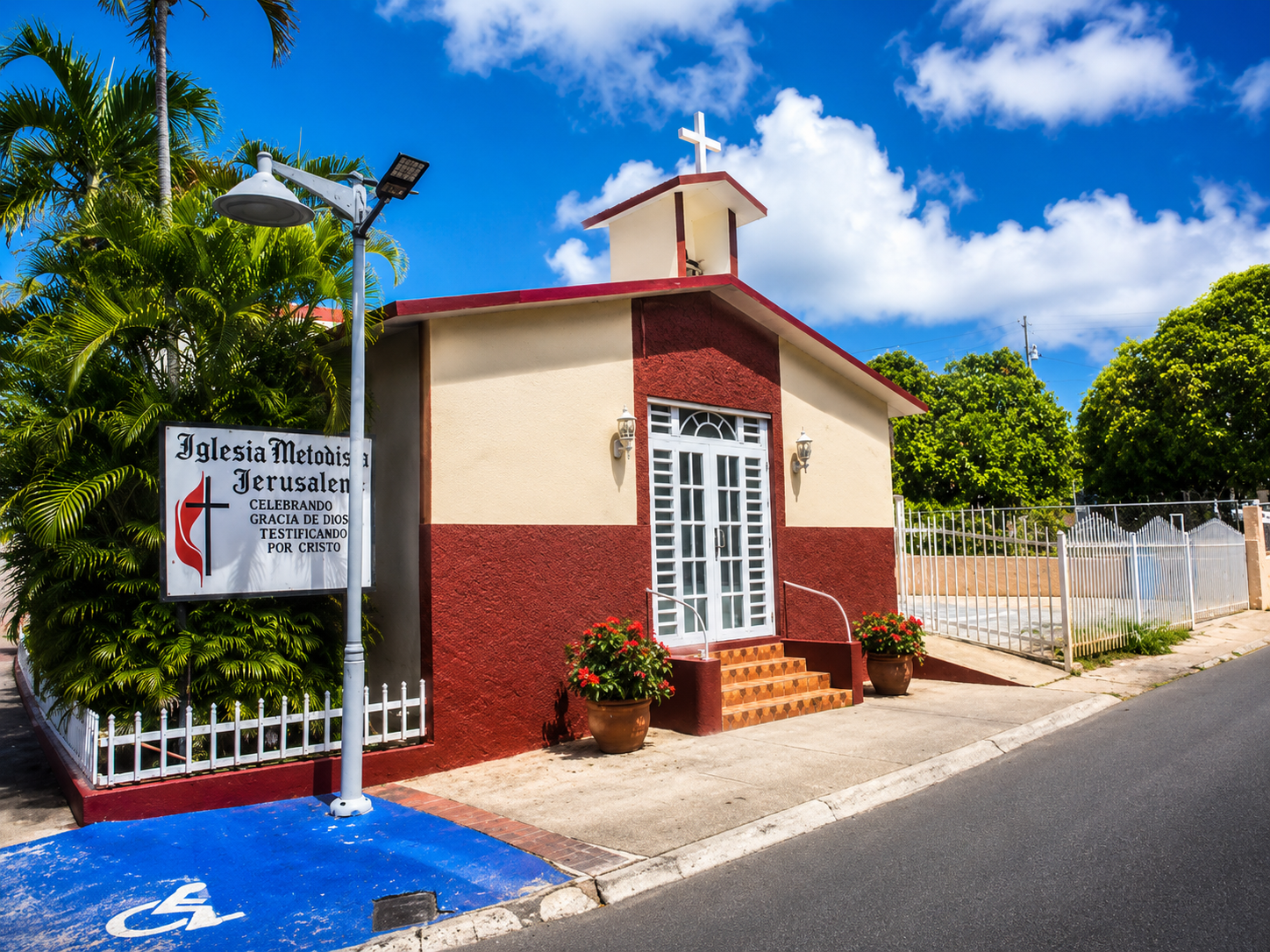 A peaceful Culebra chapel framed by palm trees and rolling hills