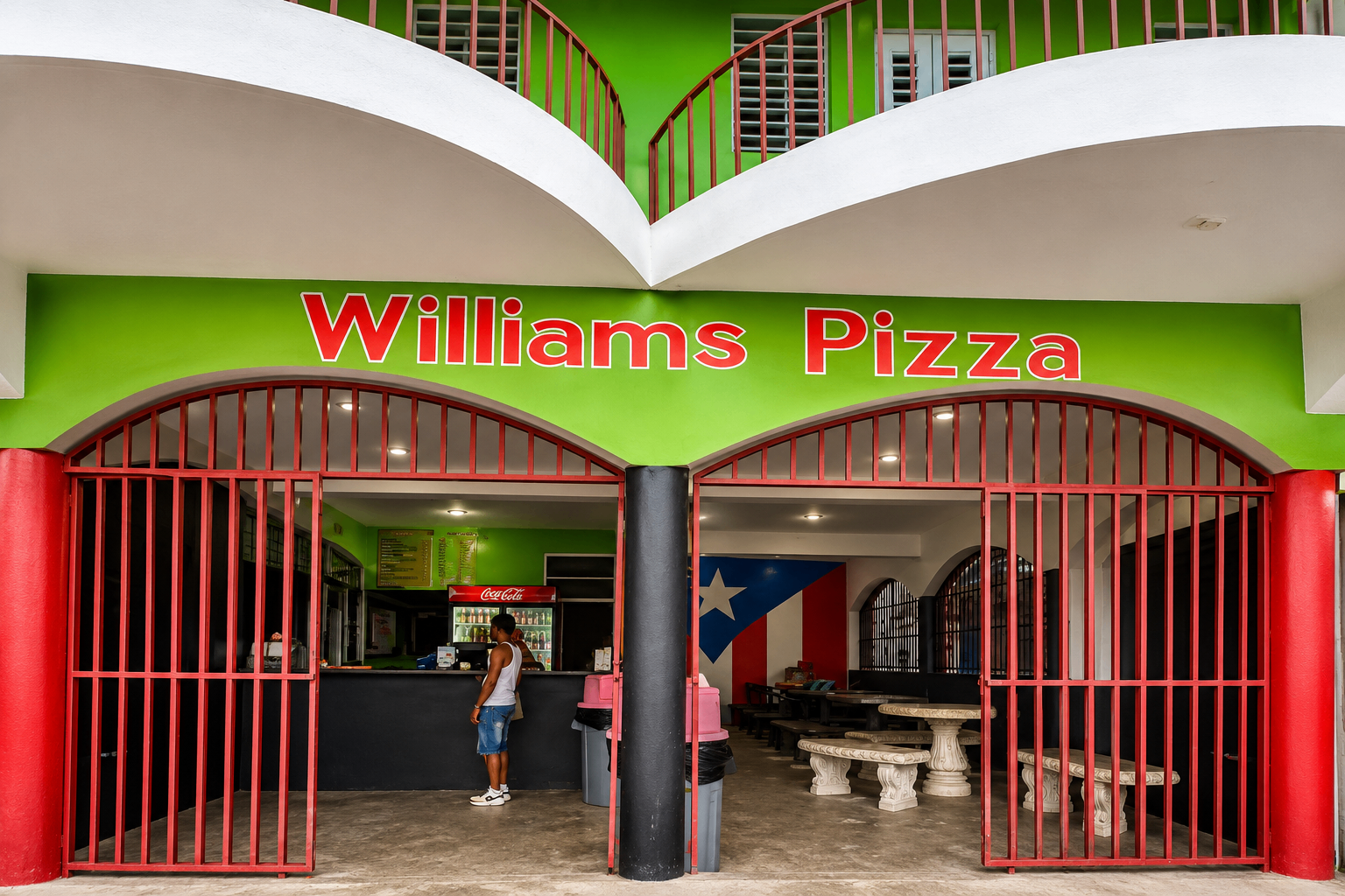Williams Pizza — vivid green façade with red arched gates near the Culebra ferry