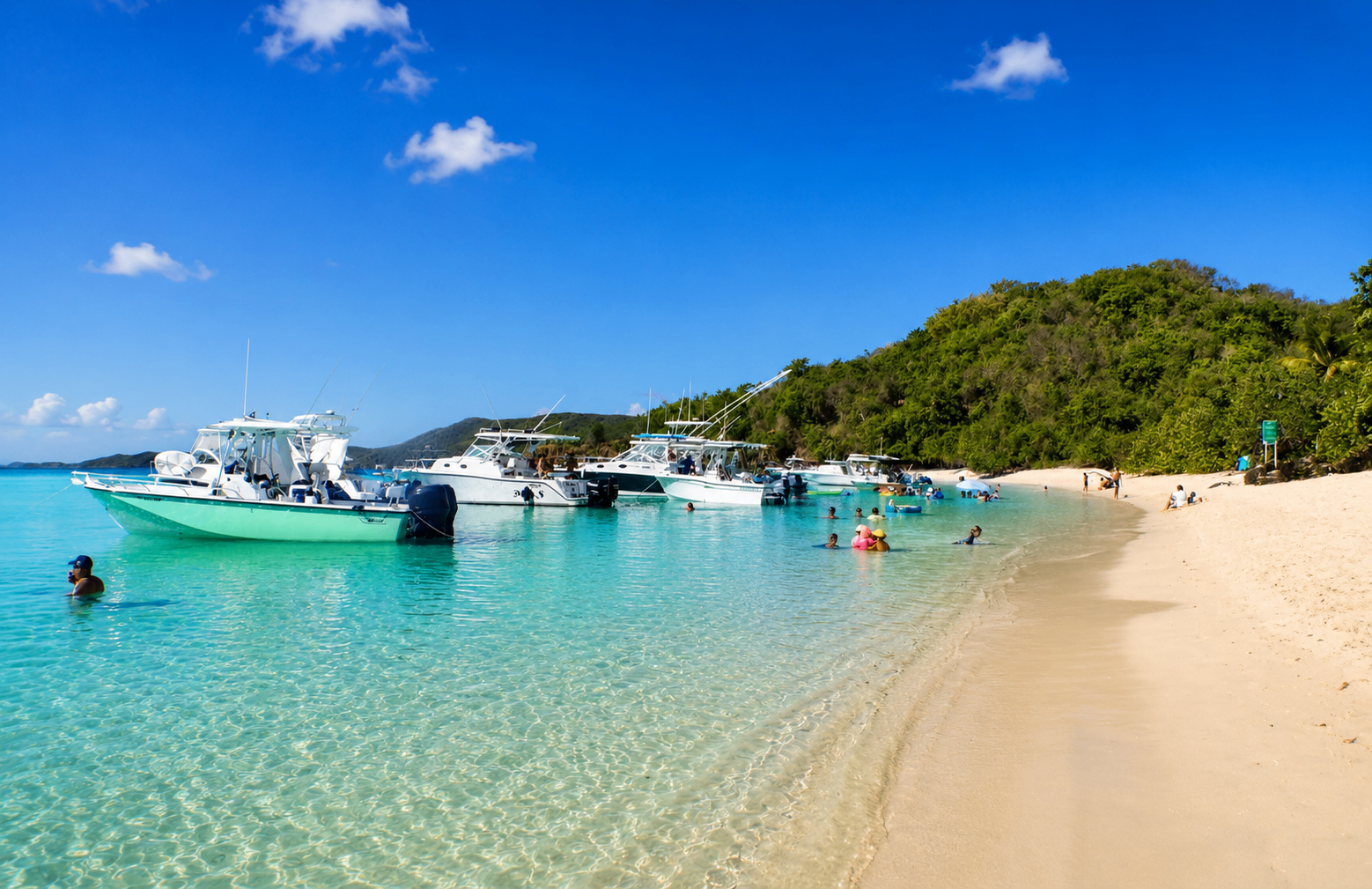 H2O Water Taxi boats anchored in the turquoise shallows off Culebrita's beach
