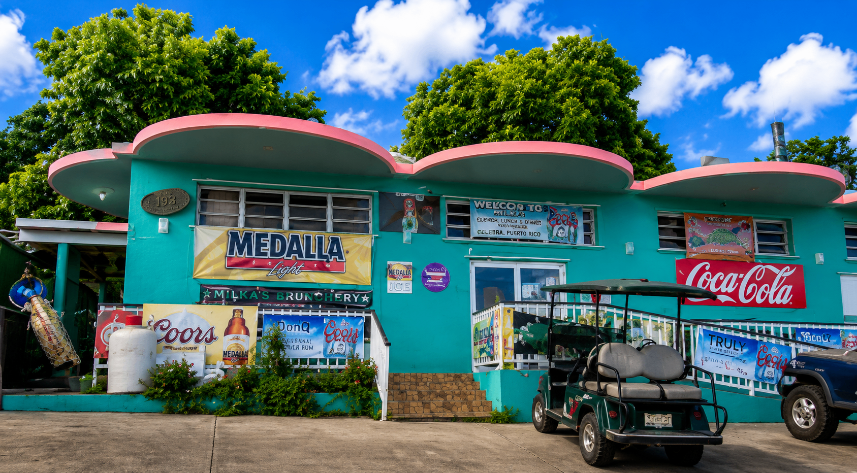Costa del Sol β colorful storefront near Culebra Airport with tropical signage