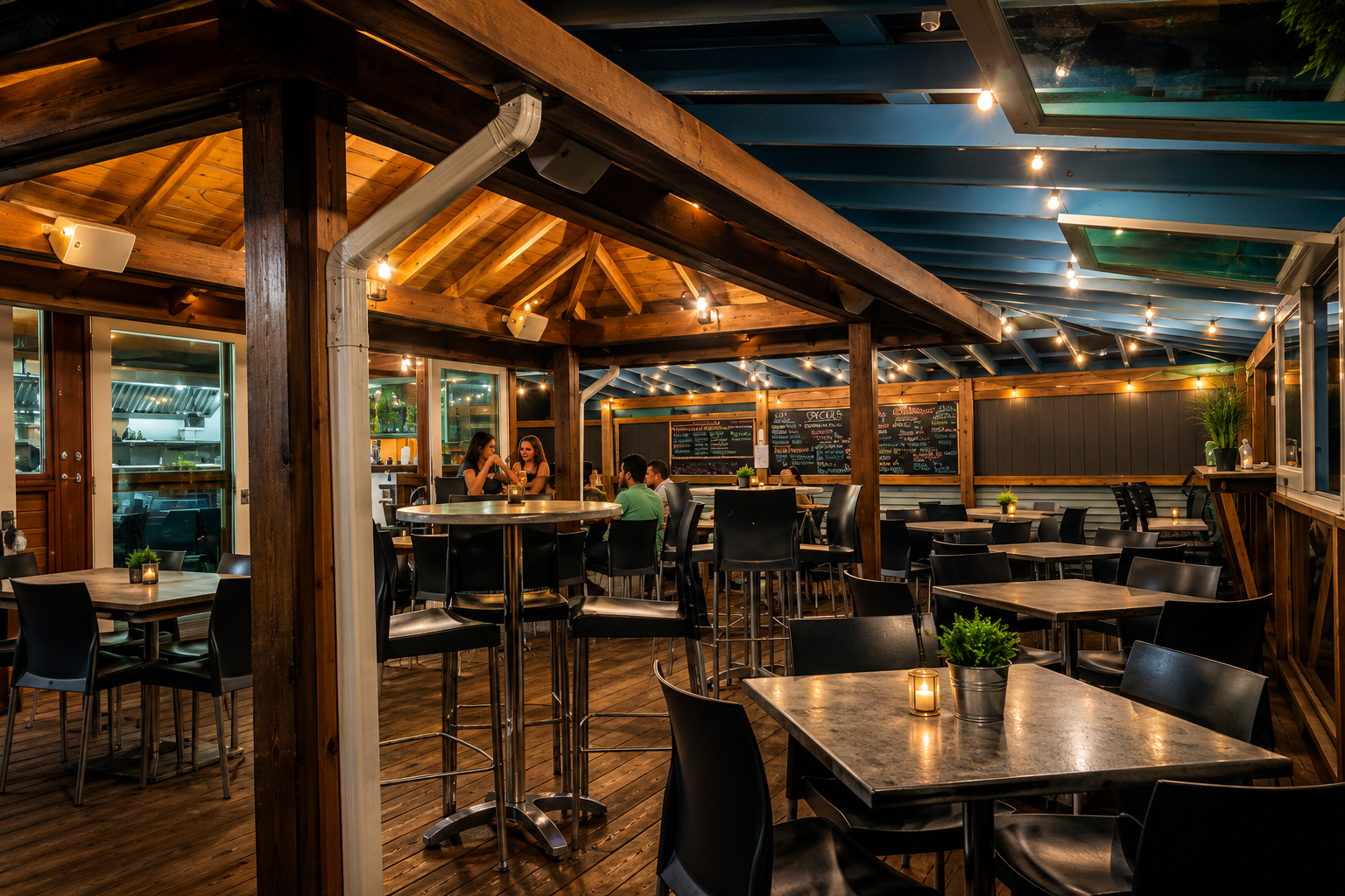 La Cocina del Navegante — wooden covered dining deck with warm string lights at night