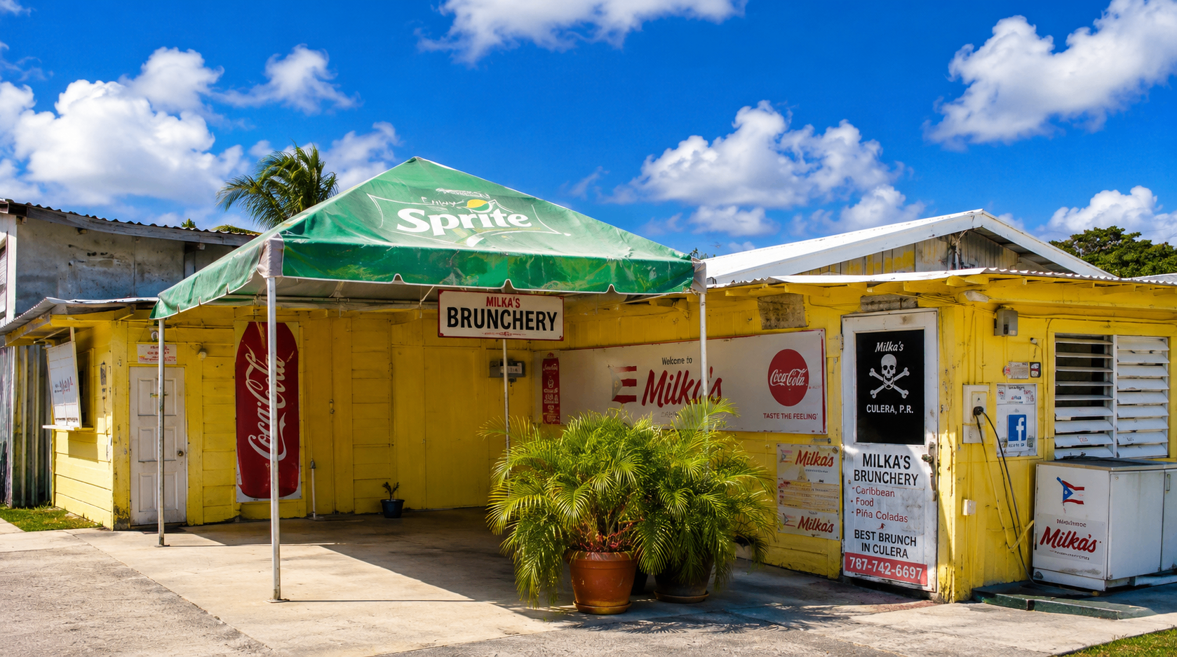 Colmado Milka β bright yellow storefront with Sprite awning on Calle Escudero, downtown Culebra